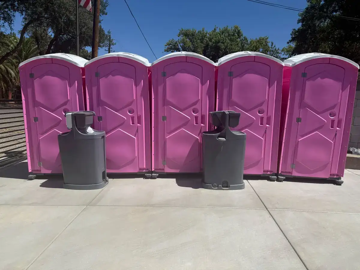 Five portable toilets and two hand wash stations at an event